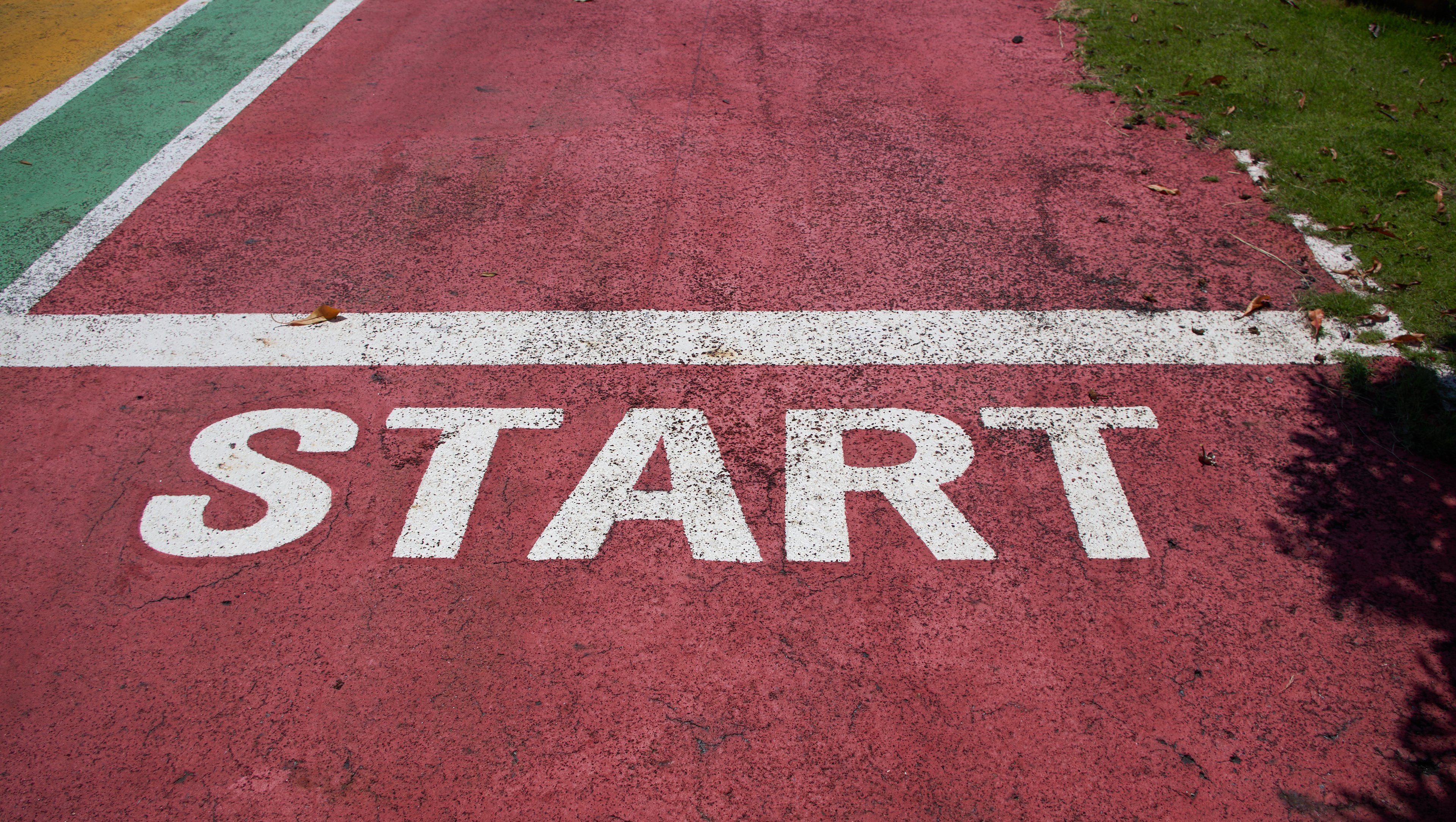Hands holding a note that reads 'Let's start the journey'